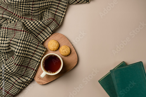 Composition with soft plaid, cup of tea and book. Copy space