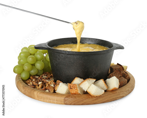 Fototapeta Naklejka Na Ścianę i Meble -  Dipping piece of bread into fondue pot with tasty melted cheese isolated on white
