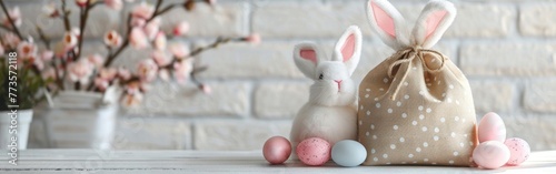 Easter Bunny Gift Bag with Eggs and Decorations on White Table - Holiday Greeting Card Concept photo