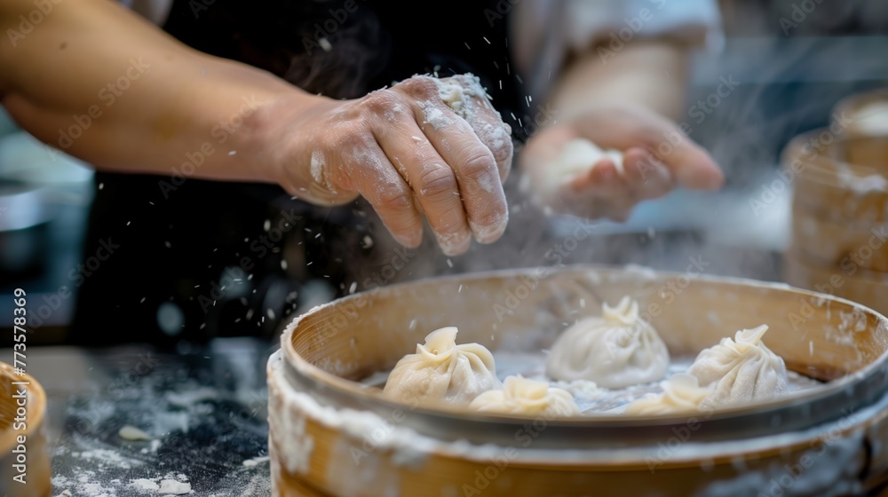 Fototapeta premium A close-up view of a chef's hands as they expertly prepare fresh dumplings in a bustling kitchen environment.