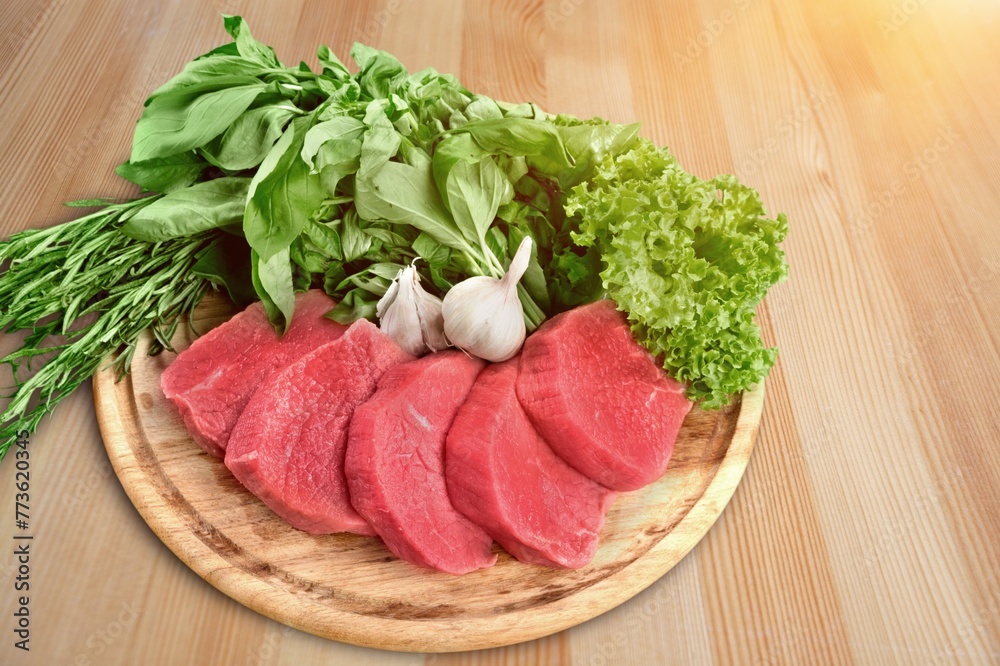 Juicy raw fresh meat with spices on plate Juicy raw fresh meat with spices on plate