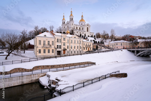 View of the Assumption Mountain, the Holy Spirit Monastery and the Holy Assumption Cathedral on the bank of the Vitba river on a sunny winter day, Vitebsk, Belarus