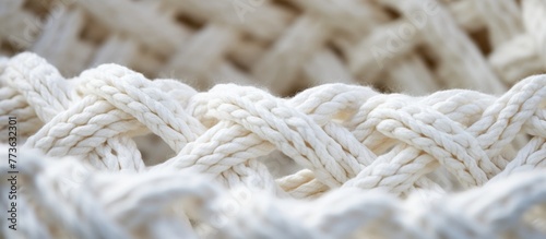 White woven basket made of rope, featuring a tightly tied knot at the top