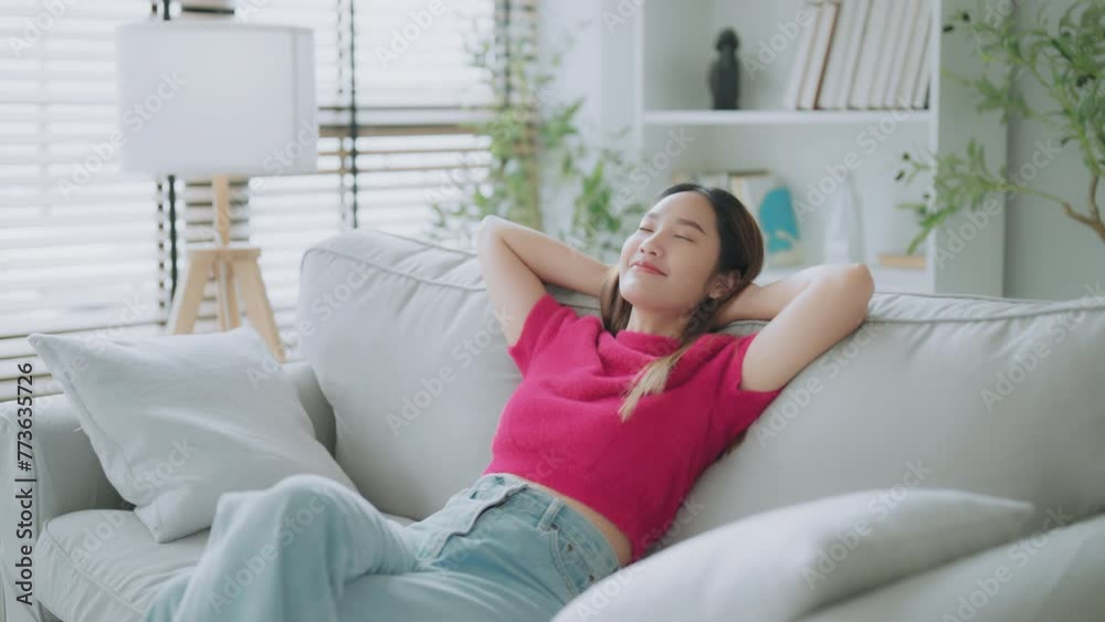 Relaxed young Asian woman enjoying rest on comfortable sofa, calm attractive girl relaxing on couch, breathing fresh air with eyes closed, meditating at home Relaxed young Asian woman enjoying rest on comfortable sofa, calm attractive girl relaxing on couch, breathing fresh air with eyes closed, meditating at home