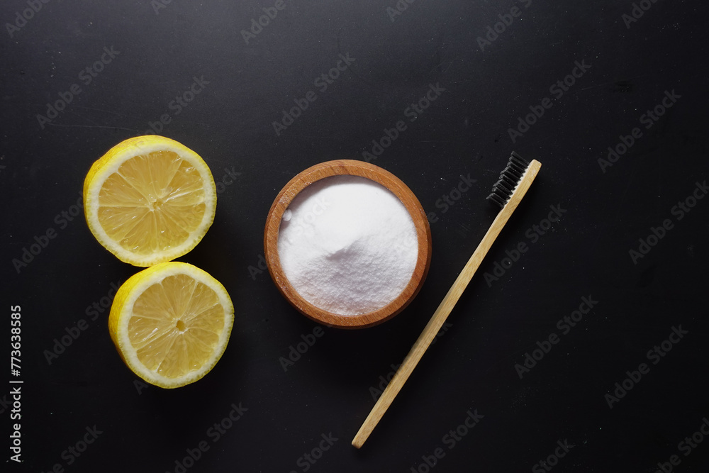 Baking soda and whole lemon on black background Baking soda and whole lemon on black background