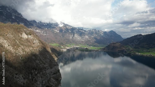 Flying Close To Rocky Mountains On Walensee Unterterzen Lake In Switzerlan photo