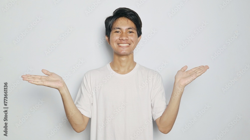 Excited young Asian man in white shirt showing open palms