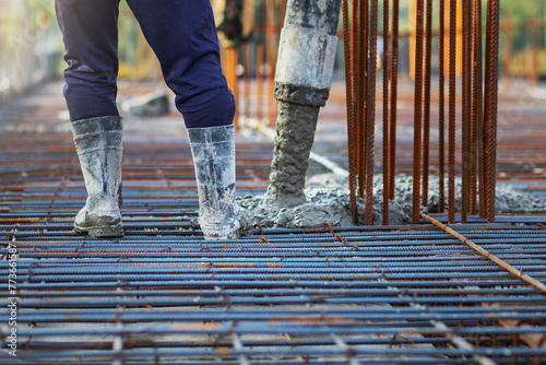 Vászonkép Concrete is being poured into a steel reinforcement frame at the construction site to form the structure's foundation or component