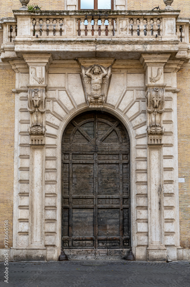The beautiful door of San Callisto Palace (Palazzo di San Callisto) in Trastevere district, Rome, Italy