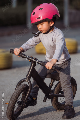 Photo of Asian Child pratice riding bicycle in the park outdoor  photo