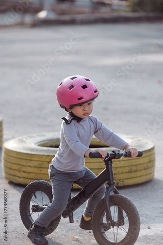 Photo of Asian Child pratice riding bicycle in the park outdoor 