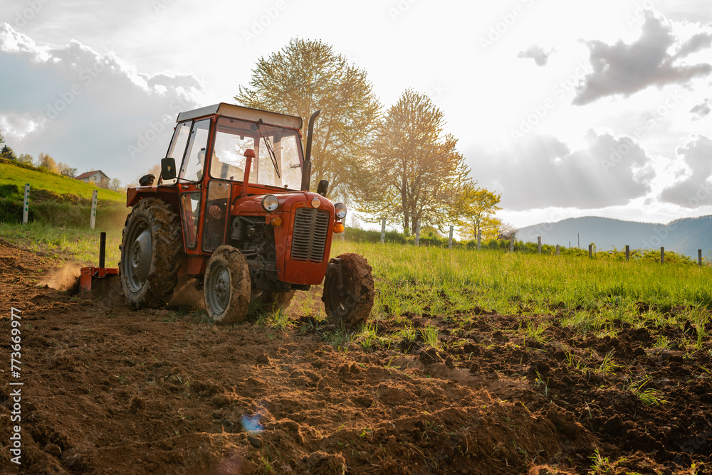 Farmer in tractor sowing crops at agricultural fields in spring. Farmer in tractor sowing crops at agricultural fields in spring.