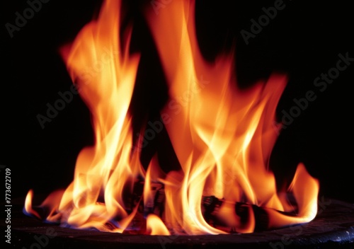 A fire is burning in the background of a black and white photo