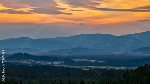 Panoramic sunset view seen from mountain resort Petzen, Karawanks, Carinthia, border Austria Slovenia. Looking at idyllic Jauntal Valley in Bleiburg, Völkermarkt. Tranquil serene hill landscape photo