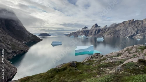 Static view of the fjord with icebergs at Bear Islands. Scoresbysund, Greenland. photo
