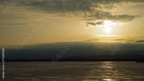 Beautiful panoramic view of the frozen lake at sunset. Beauty is in nature. Winter background.