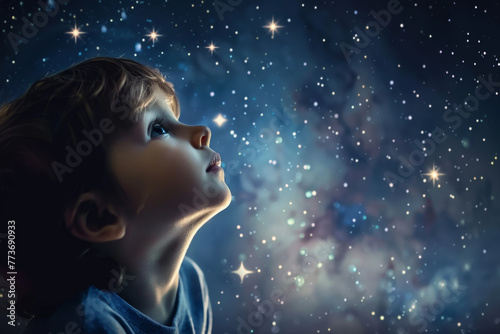 A young boy is looking up at the stars in the sky