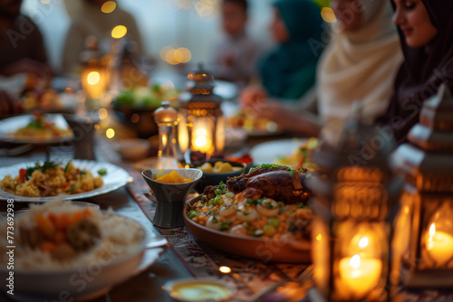 A group of people are gathered around a table with a variety of food