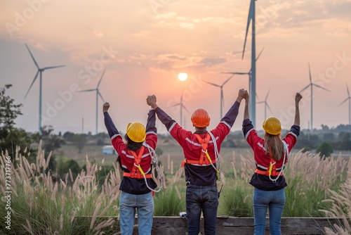 engineer technician team raise joy hand for success happiness at wind power plant machine . silhouette Group of colleague technician professional worker discussion maintenance electronic wind turbine photo