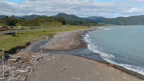 Calm ocean beach, driftwood and headlands. Raukokore, Bay of Plenty, New Zealand. photo