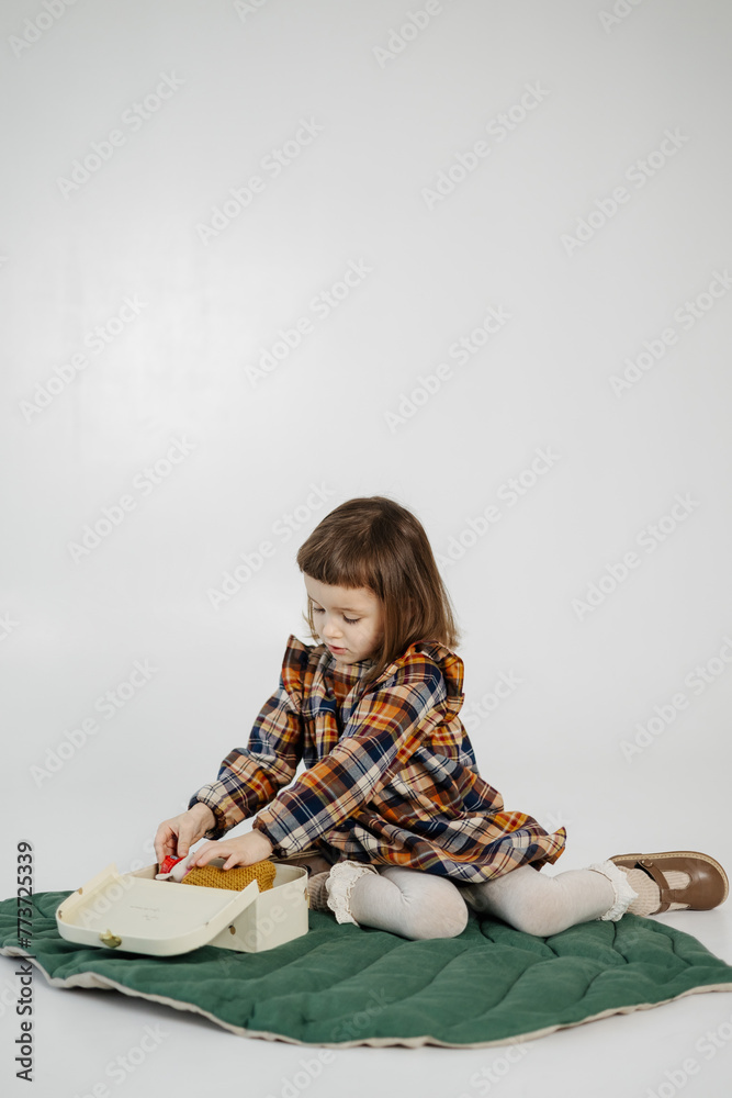 studio portrait of a little smiling girl lying on the floor and positively looking at the camera studio portrait of a little smiling girl lying on the floor and positively looking at the camera