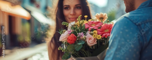 Woman receiving a bouquet of flowers from gentleman photo