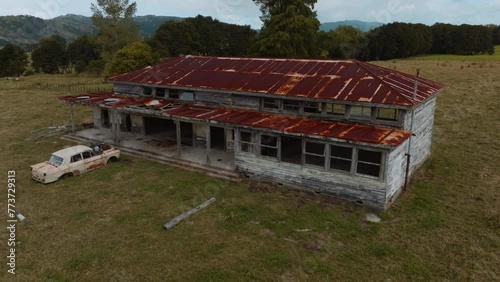 Abandoned building and rusting car. Tikitiki, Gisborne, New Zealand. photo