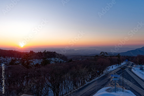 High angle view of empty car parking at Tottori Flower Park with sunset  scenic landscape and bay of water in the background on a sunny winter day. Photo taken February 13th  2024  Tottori  Japan.