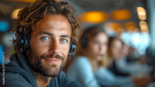 Close up portrait of a handsome man wearing headphone. Photography for call center employee, freelance, assistant, communicating online, tech support. Looking at camera, smiling friendly. © idcreative.ddid