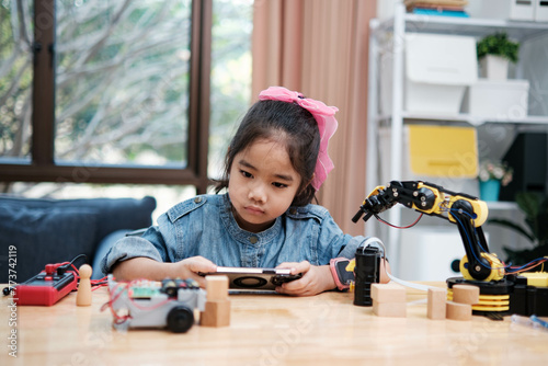 Primary School Girl Using App to Control Car in STEM Class