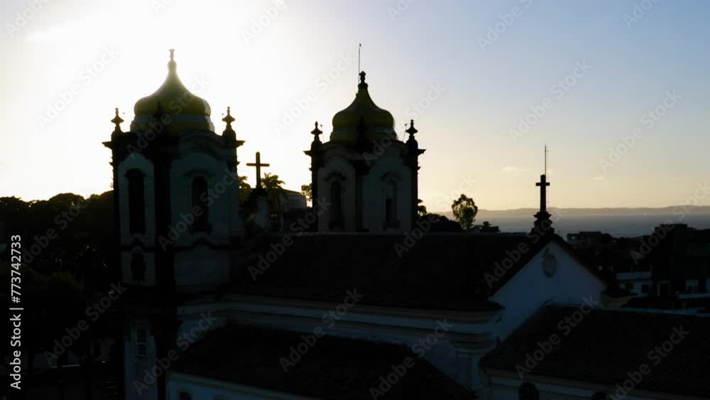 Aerial view of Nosso Senhor do Bonfim church back side, the neighbourhood and the ocean at background, at sunset, Salvador, Bahia, Brazil Aerial view of Nosso Senhor do Bonfim church back side, the neighbourhood and the ocean at background, at sunset, Salvador, Bahia, Brazil
