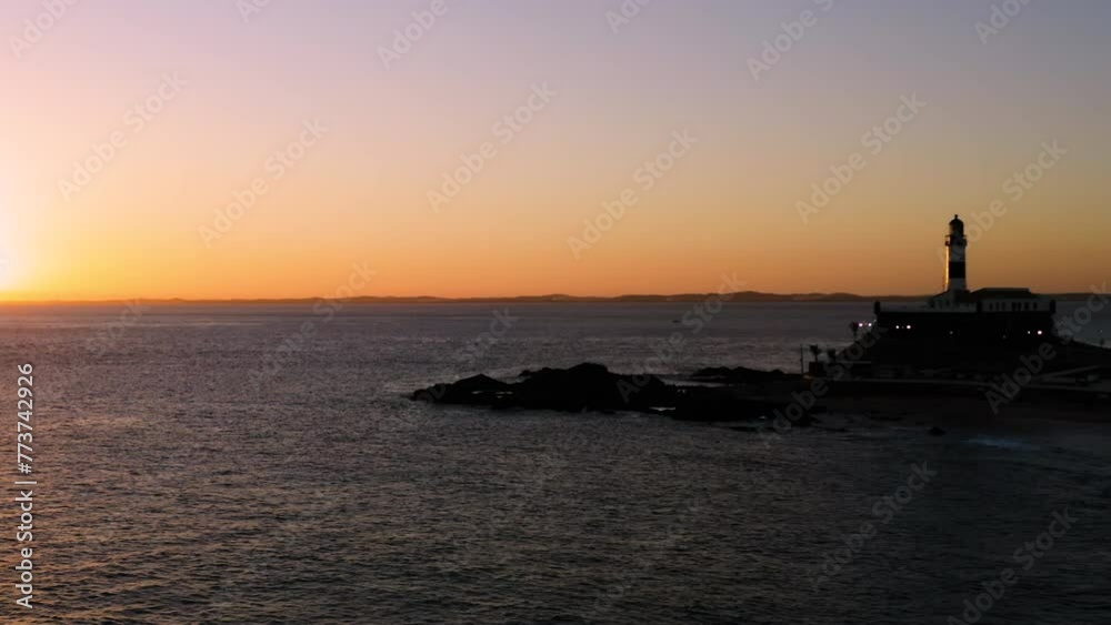 Aerial view of Farol da Barra illuminated by the sun, the neighborhood around and the sea, at sunset, Salvador, Bahia, Brazil Aerial view of Farol da Barra illuminated by the sun, the neighborhood around and the sea, at sunset, Salvador, Bahia, Brazil