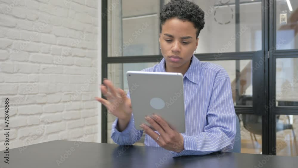 Young African Woman Using Digital Tablet in Office Young African Woman Using Digital Tablet in Office