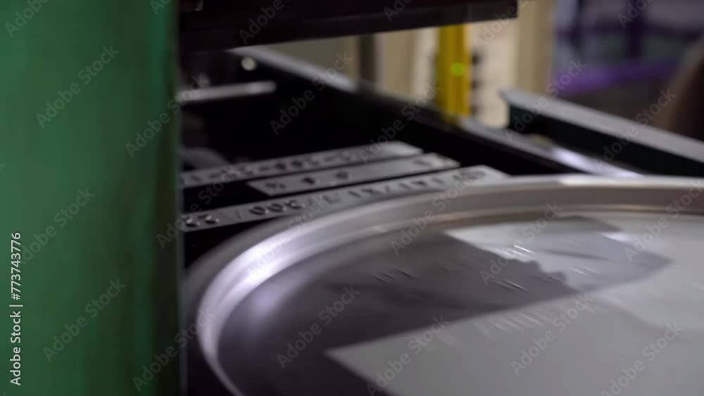 A metal stamping machine presses identification numbers into the drum lids. A metal stamping machine presses identification numbers into the drum lids.