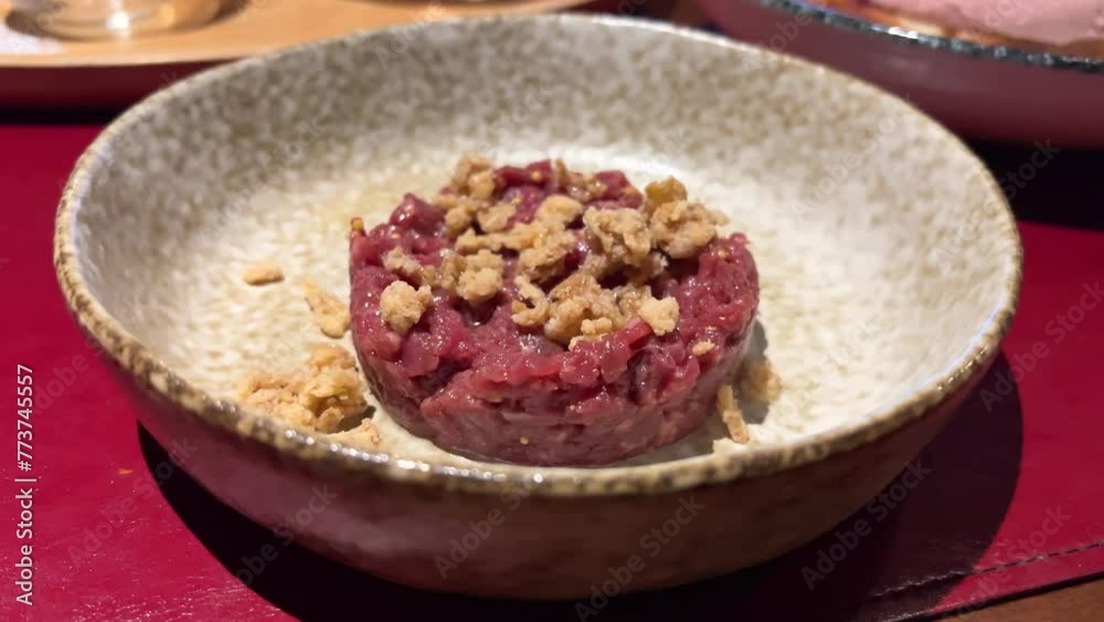 Close-up shooting a tasty Meat dish Tar Tar on stone plate. Romantic Dinner at Restaurant Close-up shooting a tasty Meat dish Tar Tar on stone plate. Romantic Dinner at Restaurant