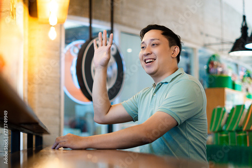 Asian man friendly Greeting at the Modern Cafe photo