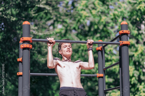 Young person doing pullups outside