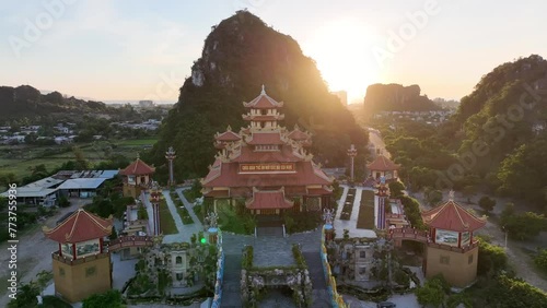 Marble Mountains at sunrise. Aerial drone video of the group of five beautiful marble and limestone hills in Da Nang, Vietnam with golden temple.