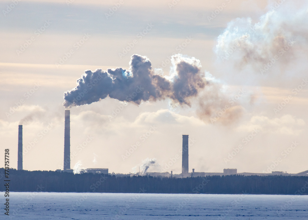 Smoke from the chimneys of a metallurgical plant in winter