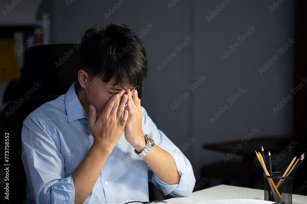 Businessman working overtime at his office makes his eyes tired. Businessman working overtime at his office makes his eyes tired.