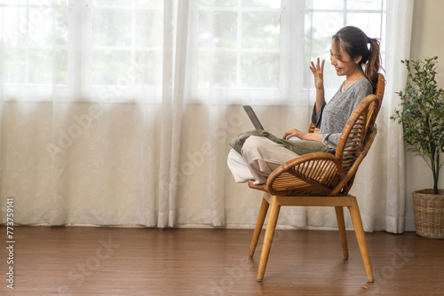 Young smiling asian woman relax using laptop conference work,learning education,study online,webinar podcast,creative woman looking at screen, shopping, online marketing at home © Art_Photo