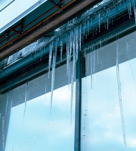 Icicles hang from a glass building