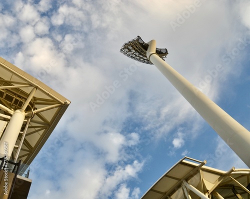 Sports stadium grandstand and light tower photo