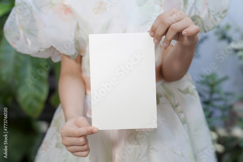 Hand showing card mockup, white blank space card, for greeting, table number, wedding invitation template. with clipping path