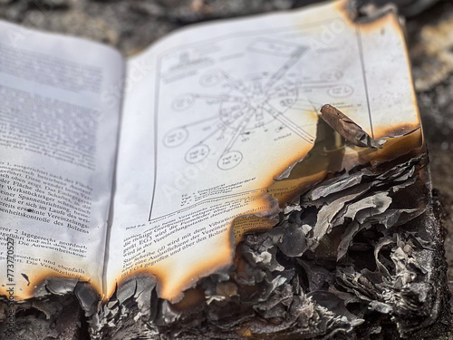 Burnt open book with burnt pages photo