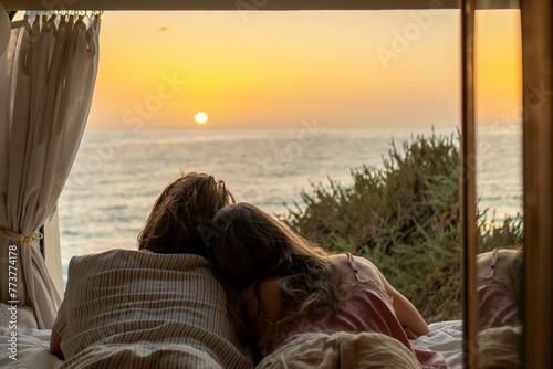 Couple Embracing Sunrise From Van by the Sea