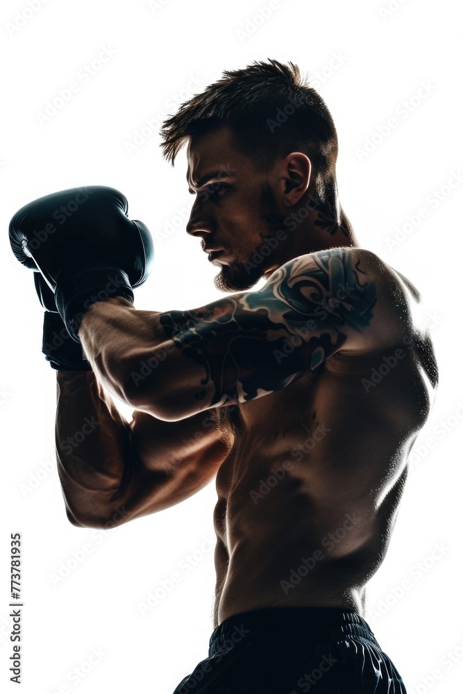 A man with tattoos on his arm is boxing