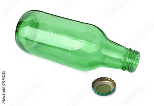 One empty green beer bottle and cap isolated on white