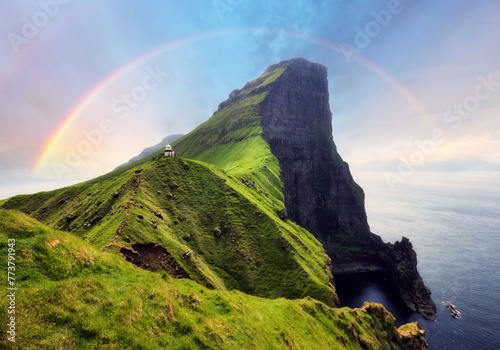 Faroe Island in Denmark with rainbow - Kallur lighthouse on green hills of Kalsoy island on sunset time, Landscape photography © TTstudio