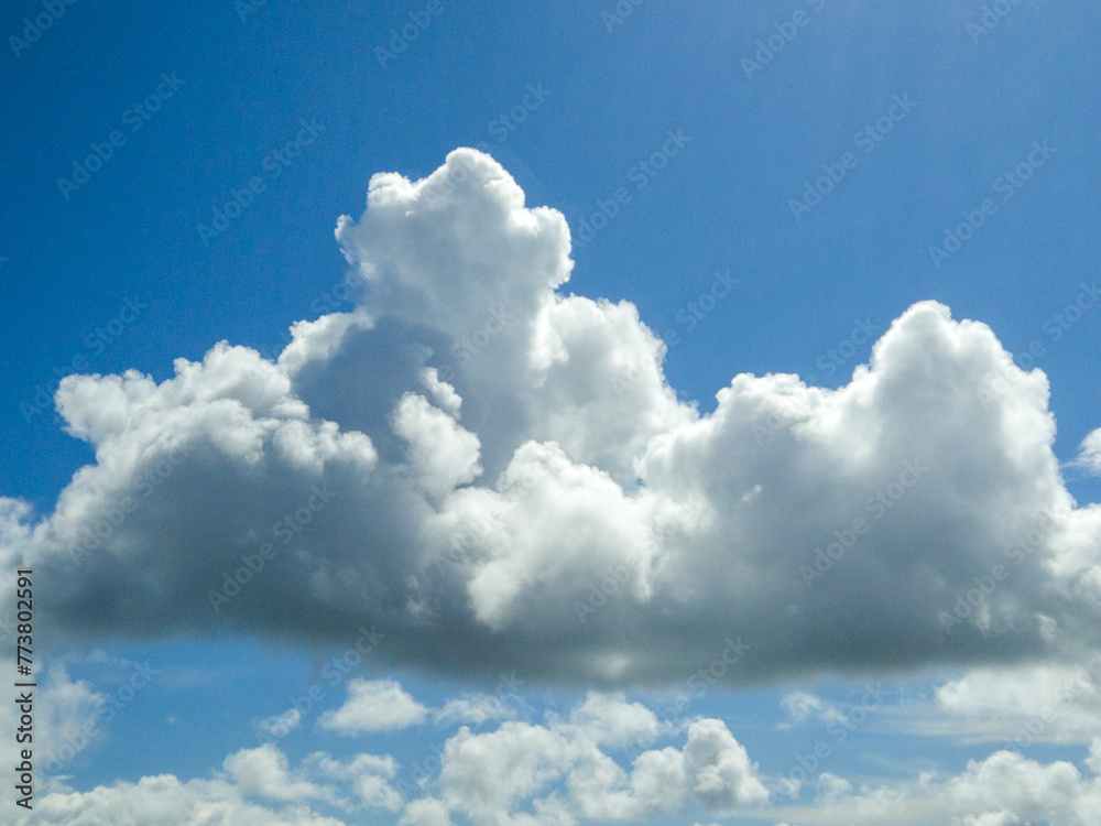 White fluffy cumulus clouds background. Summer clouds in the blue sky White fluffy cumulus clouds background. Summer clouds in the blue sky